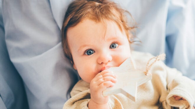 baby girl holding a star