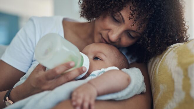 A mom giving her baby a bottle