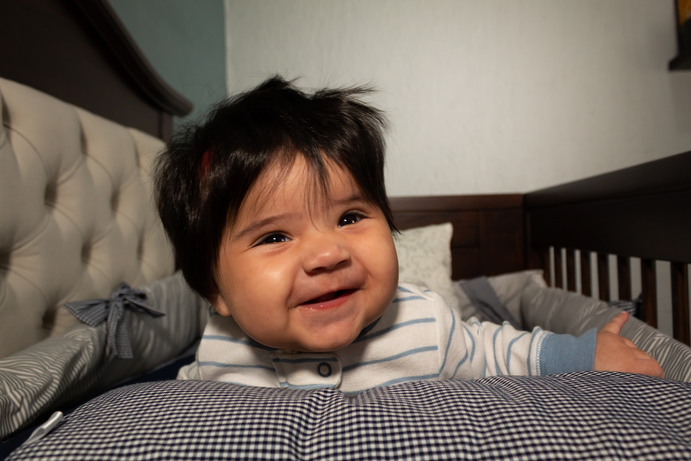 Smiling baby on a bed