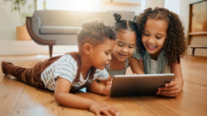 Kids playing on a tablet at home