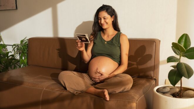 Pregnant mom looking at ultrasound photos