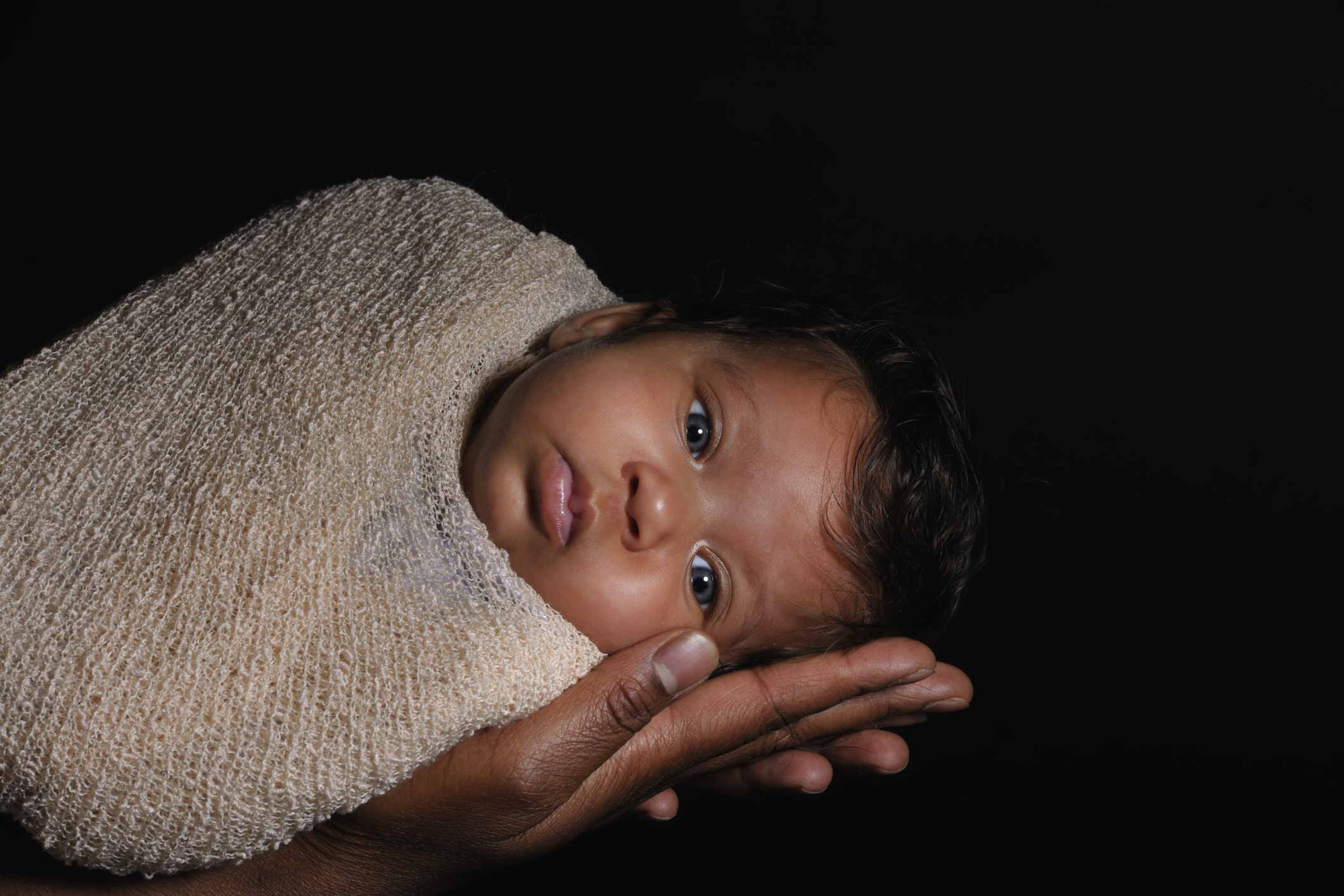 Portrait Of A Beautiful Biracial Baby Isolated On Black
