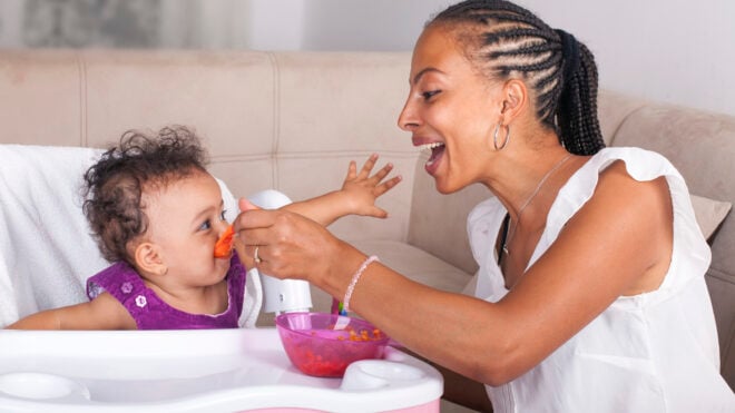 mom feeding baby solids