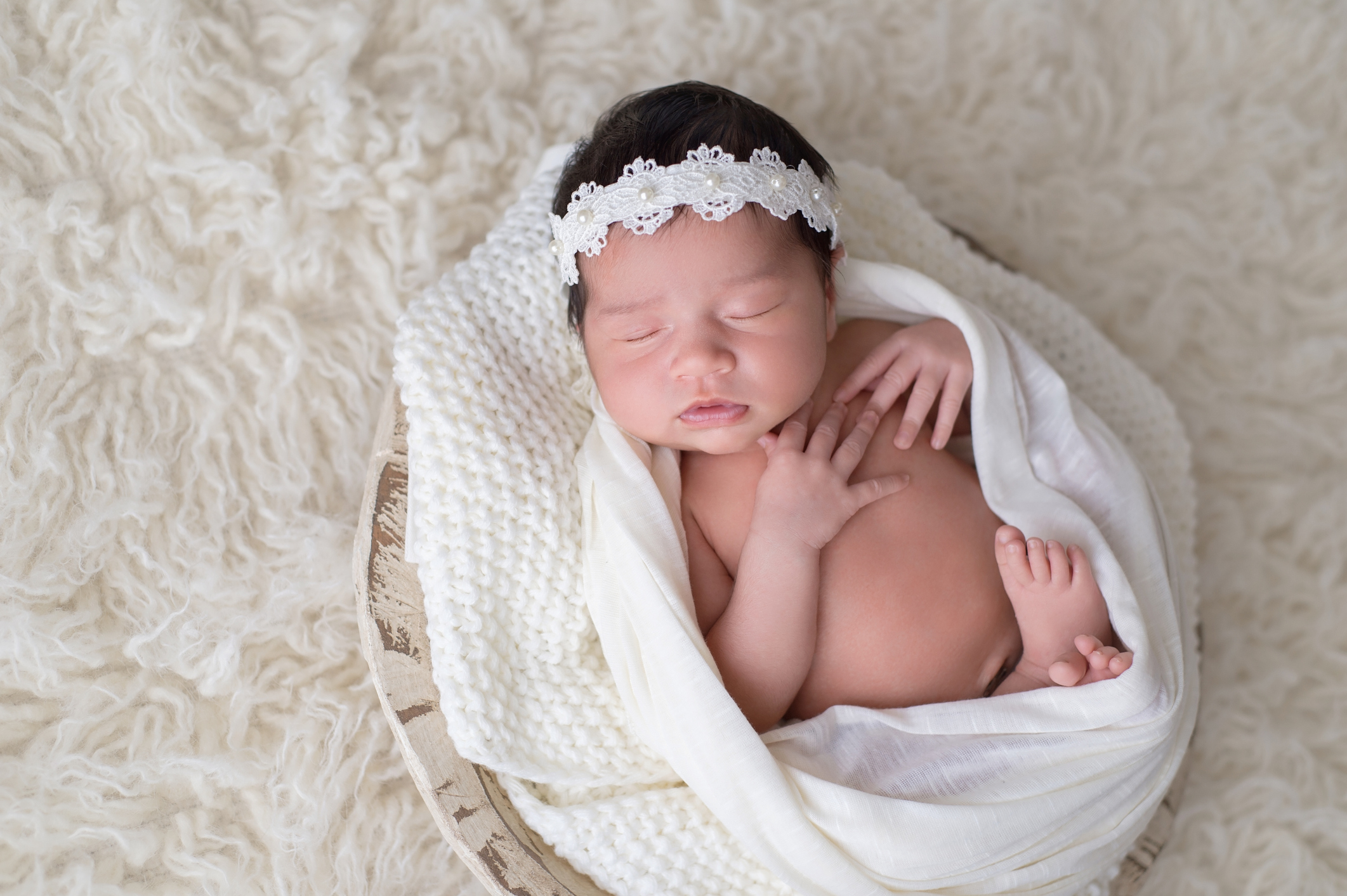Newborn Girl Wearing a Lace and Pearl Headband