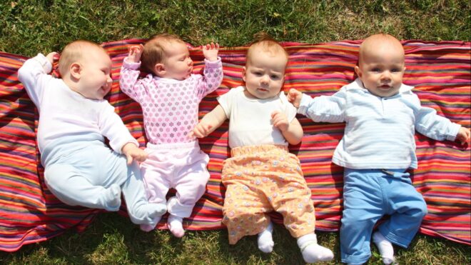 Four babies lying outside